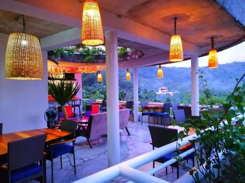 a restaurant with tables and chairs and lights at Lonos Circle Private Garden in Romblon