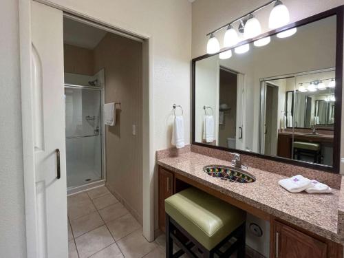 a bathroom with a sink and a large mirror at Studio 6 Carlsbad CA in Carlsbad