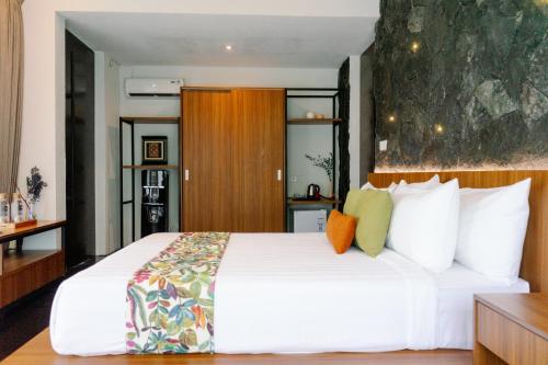 a bedroom with a large white bed with white pillows at Zenubud in Ubud