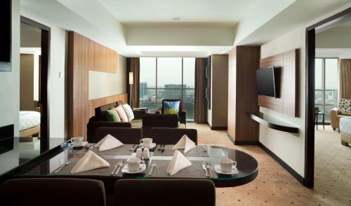 a living room with a couch and a table at Best Western Premier La Grande Bandung in Bandung