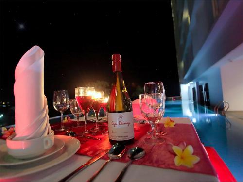 a bottle of wine sitting on a table with wine glasses at Best Western The Lagoon Hotel in Manado