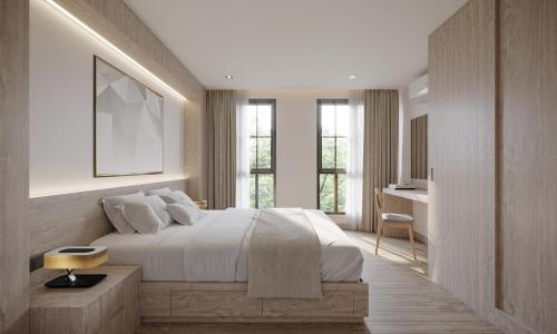 a bedroom with a bed and a desk and windows at Leon Lasalle Hotel and Residences in Bangkok