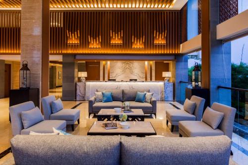 a living room with a couch and chairs and a table at Best Western Kamala Jimbaran in Jimbaran