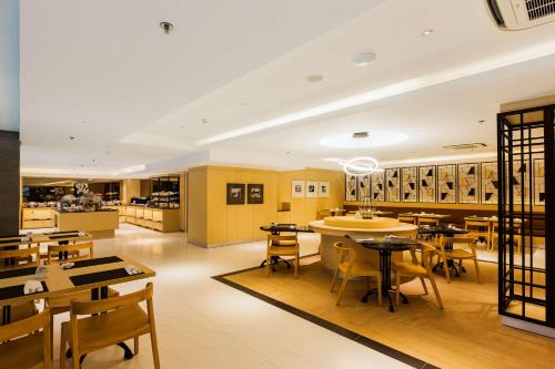 a restaurant with tables and chairs and a cafeteria at Best Western Kamala Jimbaran in Jimbaran