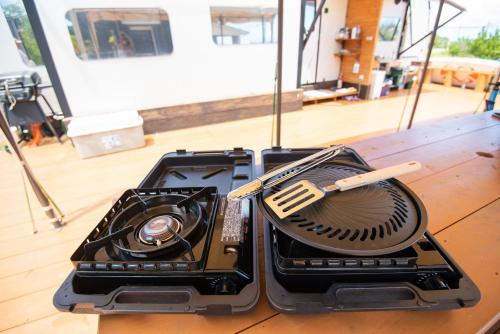 two plastic containers with utensils sitting on a table at ペットOK! JUNGLIA 15分! サウナ-プール-Private Villa 405 in Nakijin