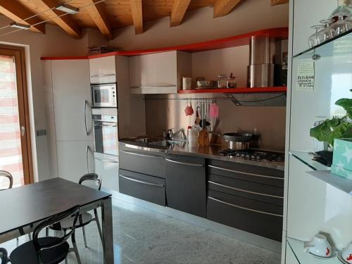 a kitchen with a counter and a table in it at CASA VACANZE RELAX in Riva di Solto