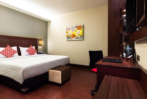 a hotel room with a bed and a desk at Best Western Senayan in Jakarta