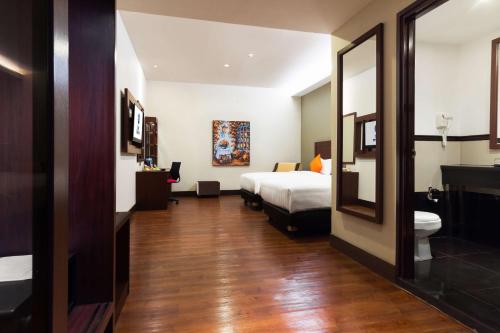 a hotel room with a bed and a mirror at Best Western Senayan in Jakarta