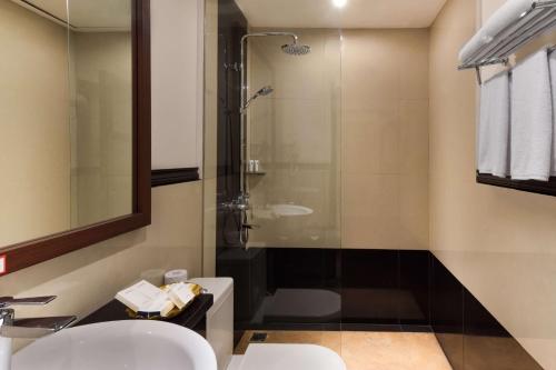 a bathroom with two sinks and a shower at Best Western Senayan in Jakarta