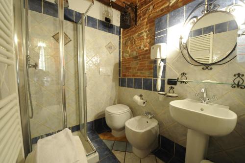 a bathroom with a toilet and a sink and a shower at Antica Corte dei Principi Charming Rooms in Lucca