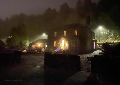 a house with christmas lights on it at night at Stables Cottage in Langholm