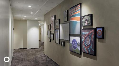 a hallway with a bunch of pictures on a wall at Center Hotels Laugavegur in Reykjavík