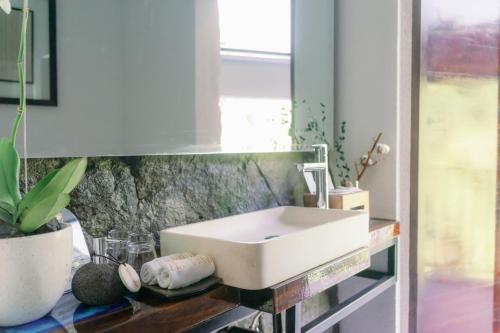 a bathroom with a white sink on a counter at Zenubud in Ubud