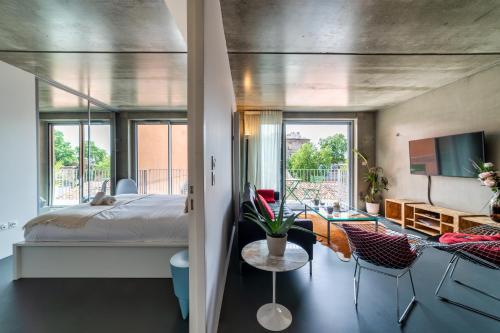 a bedroom with a bed and a living room at L'INOX in Toulouse