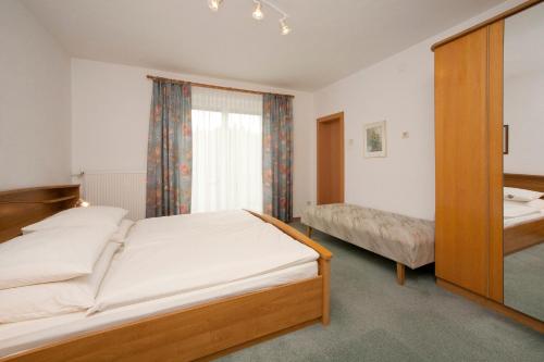 a bedroom with two beds and a window at Landhaus Zechner in Schiefling am See