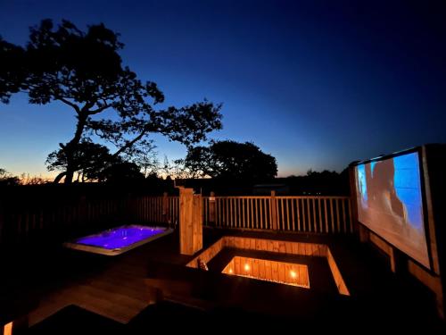 a backyard with a tv and a wooden fence at Aladdin Safari Tent in Tenby