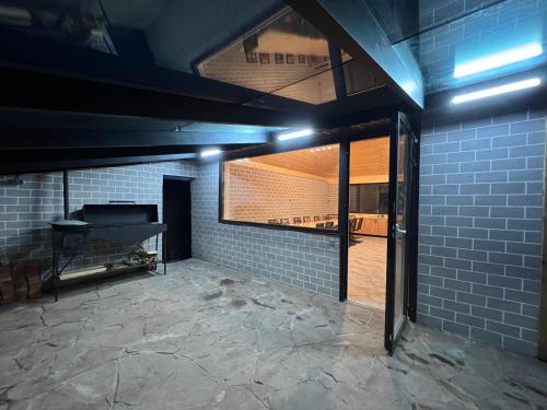 an empty room with a piano in a brick wall at По Щучьему Велению in Shchūchīnsk