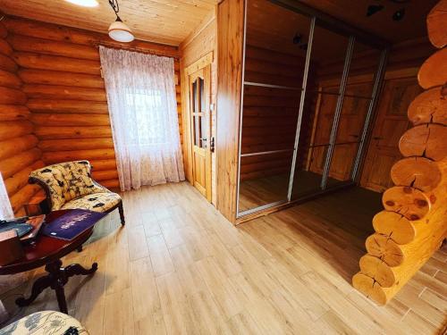 an empty room with a chair and a glass door at По Щучьему Велению in Shchūchīnsk