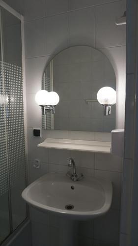 a bathroom with a sink and a mirror at Pensjonat Kowalski in Łubowo