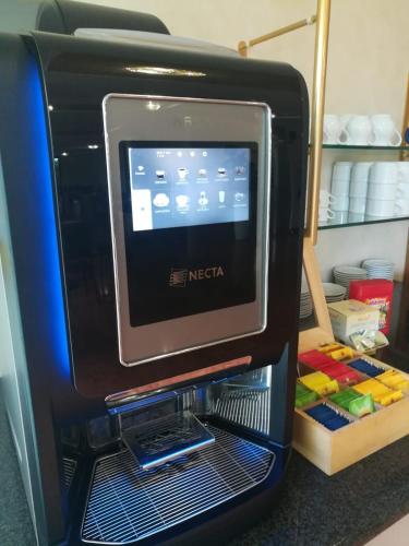 a computer monitor sitting on top of a refrigerator at Residence all'Adige in Verona