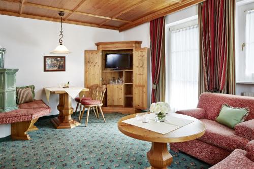 a living room with a couch and a table at Villa Angela in Mayrhofen