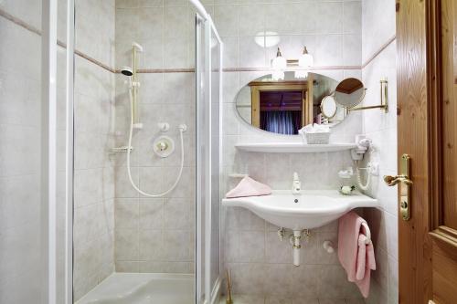 a bathroom with a sink and a shower at Villa Angela in Mayrhofen