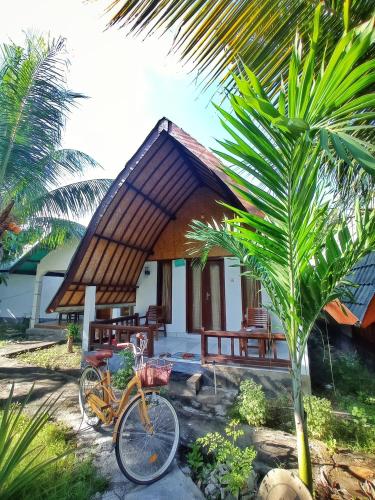 a bicycle parked in front of a small house at Follow The Rabbit Bungalow in Gili Air