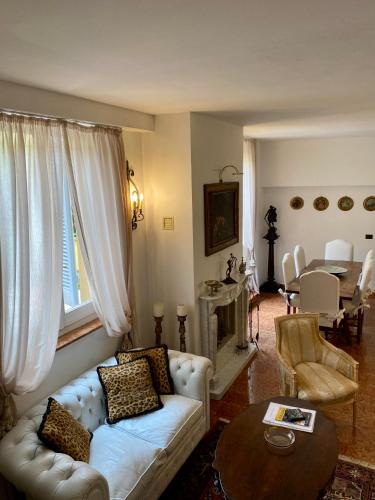 a living room with a white couch and a table at Rooftop Garden in Bologna