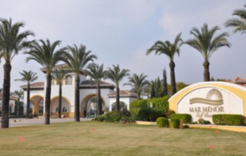 a resort with palm trees and a large building at Casa Moriarty in Murcia