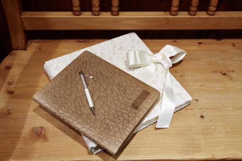 a notebook with a pen on a table with a bow at Villa Angela in Mayrhofen