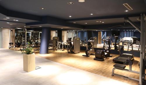 a gym with lots of treadmills and cardio equipment at Best Western Premier Ark Hotel in Tirana