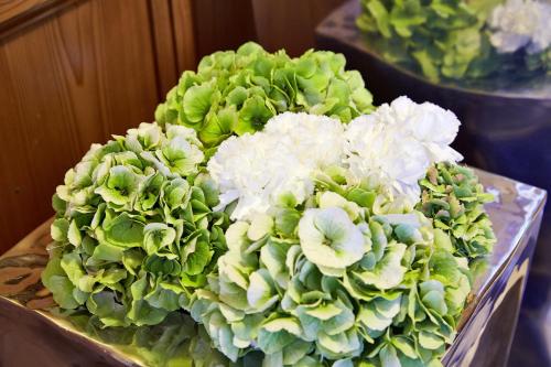 a bunch of green and white flowers on a table at Villa Angela in Mayrhofen