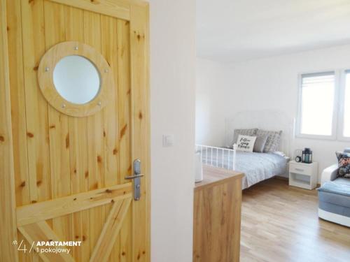 a room with a door with a bed and a mirror at Apartament Karkonoska in Przesieka