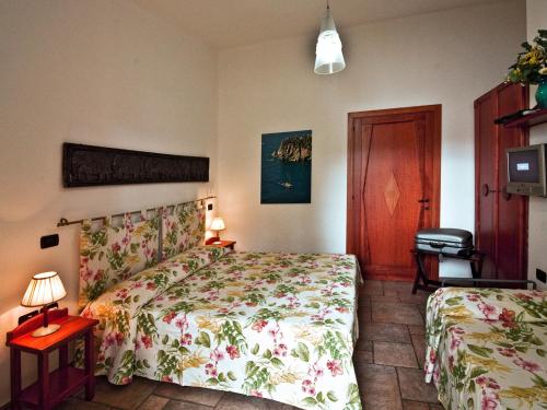 a bedroom with two beds and a door at Villaggio Camping Spiaggia Del Riso in Villasimius