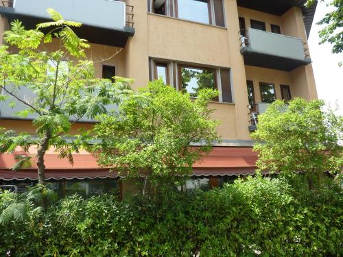 a tall building with trees in front of it at Alla Bianca Hotel in Marghera