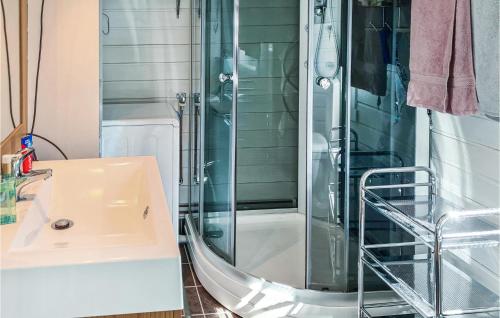 a bathroom with a glass shower and a sink at Beautiful Home In Hol I Tjeldsund With Wifi 