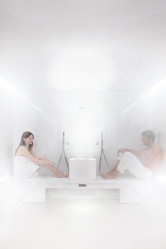 a man and a woman sitting on a white wall at Hotel Tiferno in Città di Castello
