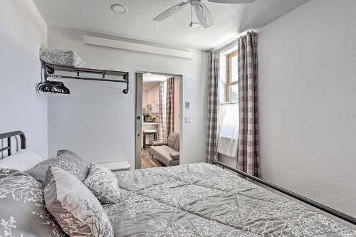 a bedroom with a bed and a ceiling fan at Modern Custer Apt - Walk to Shops and Dining! in Custer