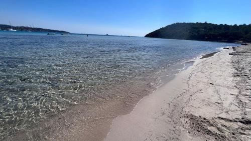 a beach with the sand and the water at Chambre d'hôtes Casa Tib in Prunelli-di-Fiumorbo