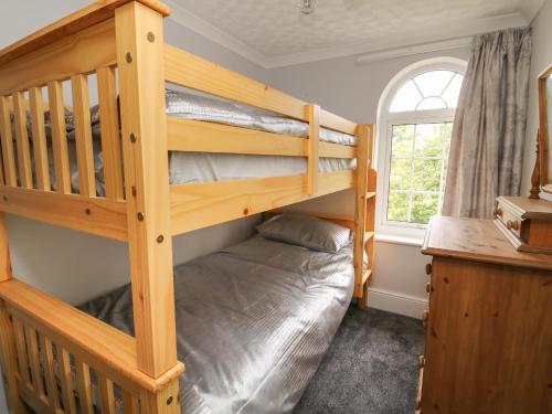 a bedroom with two bunk beds and a window at 2 Crosslands in York