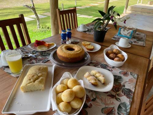 a table topped with plates of food and biscuits at Pousada Casa Caju Bangalows in Cumbuco