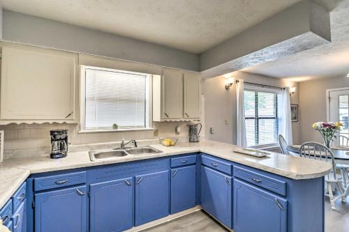 a kitchen with blue cabinets and a sink at Charming Mountain Home Getaway with Gas Grill! in Mountain Home