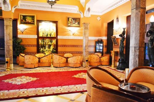 a lobby with couches and a red rug at Hôtel Transatlantique in Casablanca