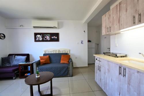 a living room with a couch and a table at The desert Pearl in Eilat