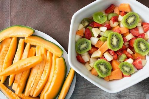 a bowl of fruit and a bowl of fruits and vegetables at Hotel Orso Bruno in Carate Urio