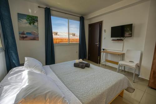 a bedroom with a bed and a large window at The desert Pearl in Eilat