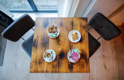 a wooden table with dishes of food on it at Bed & Breakfast Bakker Meijer in Heemskerk