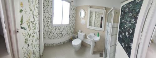 a bathroom with a white toilet and a sink at Pensión Casablanca in Santa Cruz de Tenerife