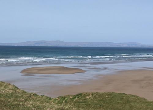 an island in the water on a beach at Padua House Holiday Home in the Centre of Bundoran and 2 mins walk to the beach in Bundoran