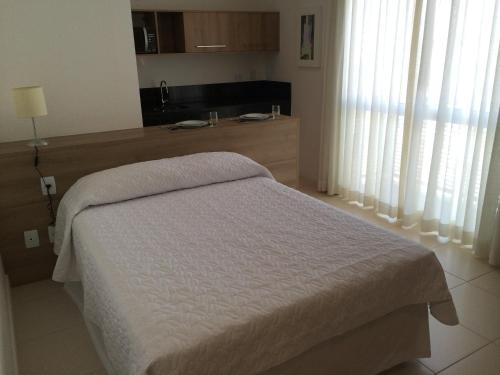 a bedroom with a bed and a kitchen at Hotel Diamond Rede Mont Blanc in Nova Iguaçu